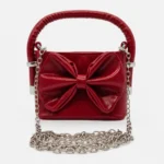 Cartera Brillante con Moño Grande